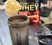 Cacito de Gold Standard Whey sobre un mezclador abierto